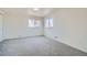 Spacious, carpeted bedroom with two large windows providing ample natural light at 5050 Steele St, Denver, CO 80216