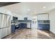 Modern kitchen features two-tone cabinets, stainless steel appliances, and hardwood floors throughout at 5050 Steele St, Denver, CO 80216