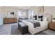 Serene main bedroom featuring two windows, a sitting area, and a plush king-size bed with stylish décor at 5050 Steele St, Denver, CO 80216