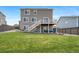 Large backyard with a well-manicured lawn, a deck with stairs, and a comfortable seating area at 18103 House Finch Ln, Parker, CO 80134
