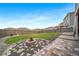 Landscaped backyard with a cozy fire pit area and a well-maintained lawn, perfect for outdoor gatherings at 18103 House Finch Ln, Parker, CO 80134