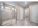 Modern bathroom featuring tiled shower with glass door and neutral color palette at 18103 House Finch Ln, Parker, CO 80134
