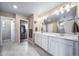 Bright bathroom with dual vanity, linen closet, and walk-in closet at 18103 House Finch Ln, Parker, CO 80134