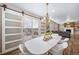 Open dining area features an elegant chandelier, access to deck, and hardwood floors at 18103 House Finch Ln, Parker, CO 80134