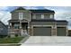 Charming two-story home featuring a welcoming front porch and a convenient two-car garage at 18103 House Finch Ln, Parker, CO 80134