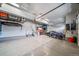Spacious garage featuring epoxy flooring, ample storage, and room for multiple vehicles and recreational equipment at 18103 House Finch Ln, Parker, CO 80134