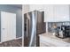 Side-by-side stainless steel refrigerator in modern kitchen with coffee bar at 18103 House Finch Ln, Parker, CO 80134