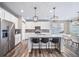Bright kitchen with stainless steel appliances, center island and pendant lighting at 18103 House Finch Ln, Parker, CO 80134
