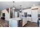 Bright kitchen features an island with stainless steel appliances, pendant lights, and hardwood flooring at 18103 House Finch Ln, Parker, CO 80134