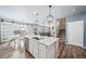 Open concept kitchen with island, stainless appliances with view to living room at 18103 House Finch Ln, Parker, CO 80134
