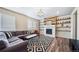 Inviting living room with fireplace, custom shelving and hardwood floors at 18103 House Finch Ln, Parker, CO 80134