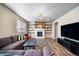 Comfortable living room with fireplace, shelving, modern rug and hardwood floors at 18103 House Finch Ln, Parker, CO 80134