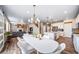 Open living space includes a fireplace, hardwood floors, dining area with pendant light and a kitchen at 18103 House Finch Ln, Parker, CO 80134
