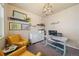 Cozy home office with neutral tones, shelving, and comfortable seating at 18103 House Finch Ln, Parker, CO 80134