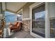 Inviting covered front porch with stone pillars and cozy seating area at 18103 House Finch Ln, Parker, CO 80134