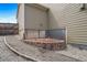 Side yard featuring a retaining wall, gravel pathway, and garden area at 18103 House Finch Ln, Parker, CO 80134