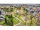 Aerial view showcases a community with a winding pond, walking paths, and a playground at 10866 W Half Moon Pass, Littleton, CO 80127