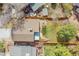 Aerial view of the home's backyard with a covered patio and woodpile in fenced yard at 10866 W Half Moon Pass, Littleton, CO 80127