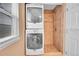 Modern bathroom with stacked washer and dryer and walk-in shower at 10866 W Half Moon Pass, Littleton, CO 80127