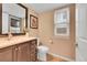 Cozy half bathroom with wood floors and large decorative mirror at 10866 W Half Moon Pass, Littleton, CO 80127