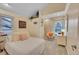 Bright bedroom with neutral tones, a large window, and comfortable seating at 10866 W Half Moon Pass, Littleton, CO 80127