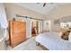 Bedroom with a view into the ensuite bathroom and an armoire at 10866 W Half Moon Pass, Littleton, CO 80127