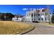 Stately white mansion featuring an American flag, grand columns, and expansive lawn against a backdrop of mountain scenery at 10866 W Half Moon Pass, Littleton, CO 80127