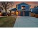 Charming two-story home with brick accents, a well-maintained lawn, and a two-car garage at 10866 W Half Moon Pass, Littleton, CO 80127