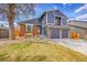 Charming two-story home with brick accents, a well-maintained lawn, and a two-car garage at 10866 W Half Moon Pass, Littleton, CO 80127