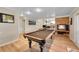 Game room featuring a pool table and a brick fireplace at 10866 W Half Moon Pass, Littleton, CO 80127