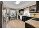 Eat-in kitchen with dark cabinets, granite countertops, and stainless-steel appliances at 10866 W Half Moon Pass, Littleton, CO 80127