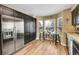 The kitchen features a stainless-steel refrigerator, black cabinets and a dining nook at 10866 W Half Moon Pass, Littleton, CO 80127