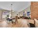 Spacious living room with high ceilings, brick fireplace, wood floors, and lots of natural light at 10866 W Half Moon Pass, Littleton, CO 80127