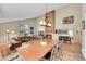 Spacious living room with high ceilings, brick fireplace, wood floors, and lots of natural light at 10866 W Half Moon Pass, Littleton, CO 80127
