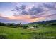 Open space landscape view with sunset over rolling hills and native vegetation at 10866 W Half Moon Pass, Littleton, CO 80127