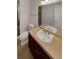 Well-lit bathroom featuring a vanity with countertop, a toilet, and a glass-enclosed shower at 24955 E Roxbury Pl, Aurora, CO 80016