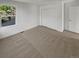 Neutral bedroom featuring carpet, a window providing natural light, and a closet for ample storage at 24955 E Roxbury Pl, Aurora, CO 80016