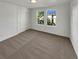 Bright bedroom with carpet, a double window with green views, and a closet for ample storage at 24955 E Roxbury Pl, Aurora, CO 80016