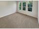 Inviting bedroom featuring soft carpeting, three large windows, and a soothing neutral color palette at 24955 E Roxbury Pl, Aurora, CO 80016