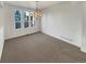 Bright dining room with large windows and elegant chandelier lighting at 24955 E Roxbury Pl, Aurora, CO 80016
