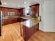 Gourmet kitchen with stainless steel appliances, ample counter space, custom cabinetry and hardwood floors at 24955 E Roxbury Pl, Aurora, CO 80016