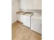 Laundry room with washer, dryer, sink and white storage cabinets above at 24955 E Roxbury Pl, Aurora, CO 80016