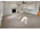 Spacious living room with built-in bookshelves and a cozy fireplace at 24955 E Roxbury Pl, Aurora, CO 80016