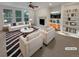Bright living room with fireplace, built-in bookshelves, and large windows, showcasing modern decor at 24955 E Roxbury Pl, Aurora, CO 80016
