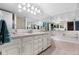 Bright bathroom featuring a double vanity, large mirror and bathtub at 7160 W Stetson Pl # 27, Littleton, CO 80123