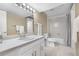 Bathroom with white cabinets, large mirror, shower and tub at 7160 W Stetson Pl # 27, Littleton, CO 80123