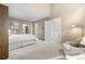 Spacious bedroom featuring light carpet, a comfortable chair and an ensuite bathroom at 7160 W Stetson Pl # 27, Littleton, CO 80123