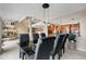 Elegant dining room adjacent to the kitchen featuring modern black table and seating at 7160 W Stetson Pl # 27, Littleton, CO 80123