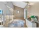 Charming foyer features hardwood floors, console table, and staircase with white railings at 7160 W Stetson Pl # 27, Littleton, CO 80123