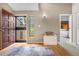 Inviting foyer with hardwood floors, stone accent table, and views into the bedroom at 7160 W Stetson Pl # 27, Littleton, CO 80123